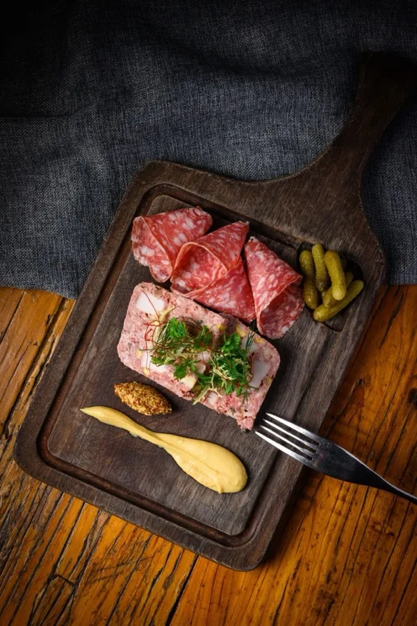 A charcuterie board of sliced dry-cured pork.