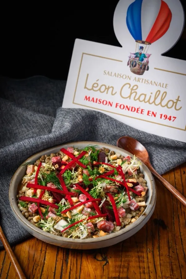 A dish served beside a Léon Chaillot table card.