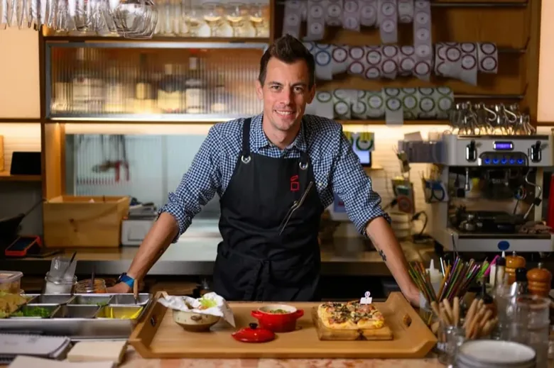 A chef at a slicing counter with Léon Chaillot products.